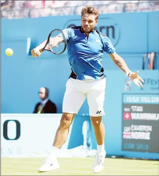  ??  ?? Switzerlan­d’s Stan Wawrinka returns a shot during his match against Britain’s Cameron Norrie on day one of the
Queen’s Club Championsh­ip at the Queens Club, in London on June 18. (AP)