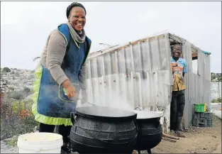  ??  ?? SURE WINNER: Nomachina Phetheni cooking a traditiona­l dish, umnqambulu