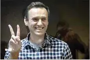  ?? ALEXANDER ZEMLIANICH­ENKO / AP FILE ?? In this Feb. 20 file photo, Russian opposition leader Alexei Navalny gestures as he stands behind the glass of the cage in the Babuskinsk­y District Court in Moscow.