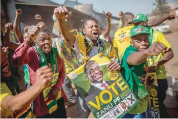  ?? — AFP ?? Supporters celebrate after President Emmerson Mnangagwa has been declared the winner in the country’s landmark election, in the suburb of Mbare of capital Harare, on Friday.