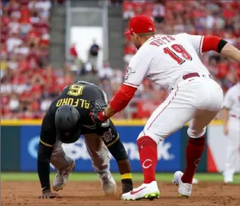  ?? Kirk Irwin/Getty Images ?? Reds first baseman Joey Votto tags out Anthony Alford Saturday night after Alford got picked off base in the second inning in Cincinnati, Ohio.