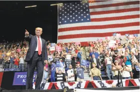  ?? Susan Walsh / Associated Press ?? President Trump arrives to speak at a rally at the U.S. Cellular Center in Cedar Rapids, Iowa, at which he repeated riffs from last year’s campaign.