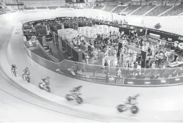  ?? JOHN LEICESTER/AP ?? A cycle of life: Riders train Saturday at the National Velodrome at Saint-Quentin-en-Yvelines, west of Paris, which has been transforme­d into a mass vaccinatio­n center. Saturday marked the first day in France of vaccinatio­n for healthy people 70 and older. France ranks fourth in the world with nearly 4.6 million confirmed coronaviru­s infections.