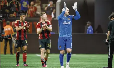  ?? JASON GETZ/JASON.GETZ@AJC.COM ?? Atlanta United goalkeeper Brad Guzan (1) and teammates celebrate after Atlanta United’s 2-1 win against San Jose during their MLS season opener at Mercedes-benz Stadium on Saturday.