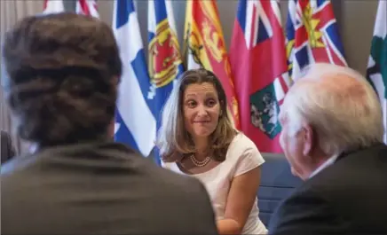  ?? CHRIS YOUNG, THE CANADIAN PRESS ?? Foreign Affairs Minister Chrystia Freeland, centre, sits with Unifor president Jerry Dias, left, and United Auto Workers president Dennis Williams in Toronto on Friday. The unions are fighting for higher wages in Mexico.