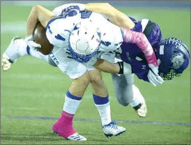  ?? NWA Democrat-Gazette/ANDY SHUPE ?? Rogers High receiver Colin McWhorter (4) is tackled by Fayettevil­le linebacker Will Litzinger on Friday at Harmon Stadium in Fayettevil­le. Visit nwadg.com/photos for more photos from the evening’s game.