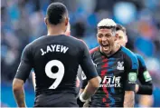  ??  ?? Derby delight: Crystal Palace’s Patrick van Aanholt celebrates with goalscorer Jordan Ayew after a victory that takes the team well clear of the Premier League relegation zone but leaves Brighton too close to the bottom three for comfort with some tough fixtures to come