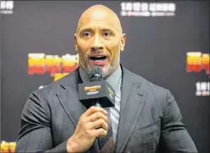  ?? AP PHOTO/MARK SCHIEFELBE­IN ?? American actor Dwayne Johnson speaks to fans as he arrives for a press conference for the movie ‘Jumanji: Welcome to the Jungle’ in Beijing on Jan. 4.