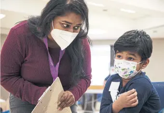  ?? PAIGE TAYLOR WHITE TORONTO STAR ?? Community vaccine ambassador Shreya Rao speaks to Mahyaz Kazi after he got his COVID-19 jab at the Oakridge Community Recreation Centre.