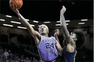  ?? REED HOFFMANN — THE ASSOCIATED PRESS FILE ?? Kansas State guard Nijel Pack (24) shoots next to West Virginia forward Isaiah Cottrell during an NCAA college basketball game in Manhattan, Kan., Feb. 14, 2022.