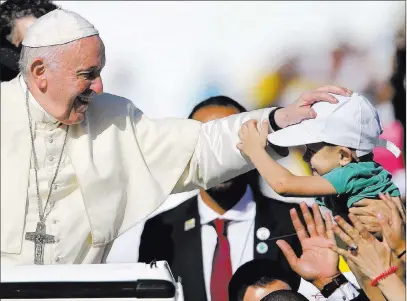  ?? Kamran Jebreili The Associated Press ?? Pope Francis blesses a boy Tuesday during a Mass at the Zayed Sports City Stadium in Abu Dhabi, United Arab Emirates.