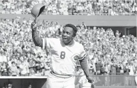  ?? [AP PHOTO/FILE] ?? Hall of Fame second baseman Joe Morgan, pictured in 1976 tipping his hat to Cincinnati Reds fans during a World Series sweep of the New York Yankees, died Sunday at his home in Danville, Calif.