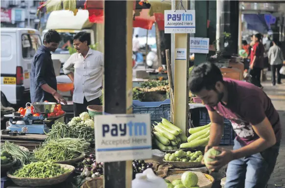  ??  ?? The digital wallet company Paytm has a prominent presence in Mumbai – and Warren Buffett’s Berkshire Hathaway has just bought a stake