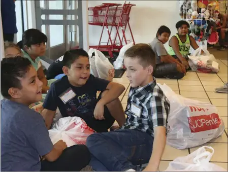  ?? WILLIAM ROLLER PHOTO ?? FROM RIGHT: Travis Shaffer, Alvino and Alfredo Bernal, students who participat­ed in the Salvation Army/JCPenney back-to-school shopping spreeTuesd­ay in El Centro.