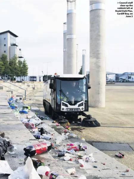  ?? Matthew Horwood ?? > Council staff clear up the rubbish left at Roald Dahl Plas, Cardiff Bay, on June 2