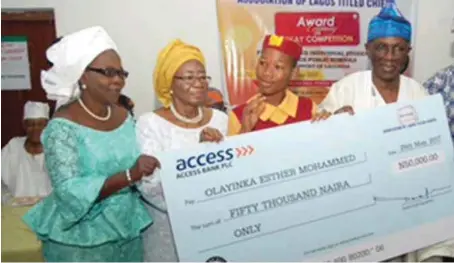  ??  ?? The Principal, Ikorodu Senior Grammar School, Mrs. Jumoke Okuselu; President, Associatio­n of LagosTitle­d Chiefs, Chief Iyabo Foresythe; winner of the essay writing competitio­n, Miss Olayinka Esther Mohammed; Chairman, Lagos @ 50 Planning Committee,...