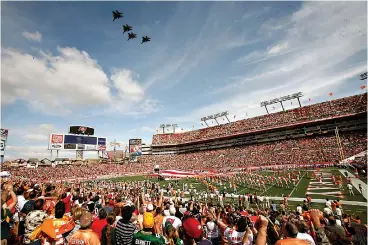  ?? AP Photo/Brian Blanco, File ?? ■ Tampa Bay Buccaneers fans cheer during a military fly over before an NFL game against the Green Bay Packers on Nov. 8, 2009, in Tampa. Hall of Famer Warren Sapp wishes the Tampa Bay Buccaneers could pack the stands for the first Super Bowl played in a host team’s home stadium.