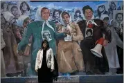  ?? NATACHA PISARENKO — THE ASSOCIATED PRESS ?? Claudia Poblete poses for a photo in front of a mural depicting the Mothers of Plaza de Mayo group, at the former Navy School of Mechanics, known as ESMA, now a human rights museum, in Buenos Aires, Argentina, on Friday.