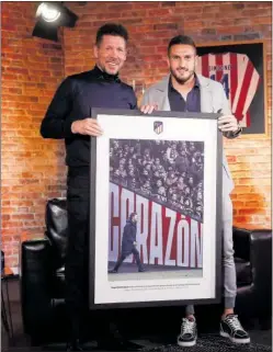  ?? ?? Simeone, con Koke, su capitán, que le entregó una foto.