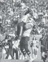  ?? JULIO AGUILAR/GETTY ?? Corey Dauphine, left, of Tulane celebrates after scoring a touchdown in the second quarter Saturday against South Florida in Tampa, Fla.