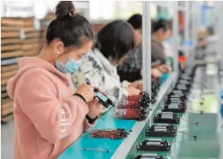  ?? AFP ?? Cadena de producción en una fábrica china en Fuyang