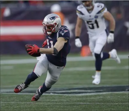  ?? CHARLES KRUPA - THE ASSOCIATED PRESS ?? New England Patriots wide receiver Julian Edelman (11) runs after catching a pass against the Los Angeles Chargers during the second half of an NFL divisional playoff football game, Sunday, Jan. 13, 2019, in Foxborough, Mass.