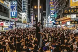  ?? Lam Yik Fei / New York Times ?? Protesters march Sunday near the Canton Road tourist shopping district in Hong Kong. The march began at a shopping area popular with mainland Chinese tourists and ended near the West Kowloon high-speed rail station that connects the city to the mainland.