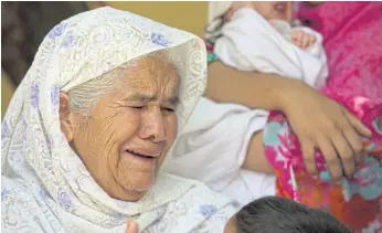  ??  ?? MATERNAL GRIEF: The mother of Pakistani journalist Bakhsheesh Elahi cries while talking about her son, with her newborn grandson in Haripur, Pakistan.