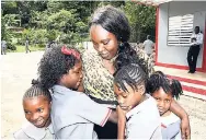  ?? NORMAN GRINDLEY/CHIEF PHOTO EDITOR ?? People’s National Party’s Keisha Hayle, principal of Padmore Primary, with some of her students at the school yesterday.