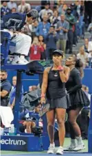  ?? AP PHOTO/ANDRES KUDACKI ?? Naomi Osaka reacts as Serena Williams talks with chair umpire Carlos Ramos after Osaka defeated Williams in the women’s final of the U.S. Open on Saturday.