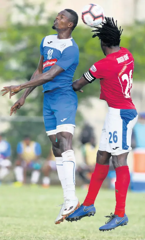  ?? RICARDO MAKYN/CHIEF PHOTO EDITOR ?? Portmore United striker Cory Burke (left) goes up for a header with Dunbeholde­n’s Shaquille Dyer during a Red Stripe Premier League game at the Spanish Town Prison Oval on Sunday, December 1, 2019.