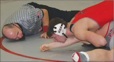  ?? CHUCK RIDENOUR/SDG Newspapers ?? Under the watchful eye of the referee, Shelby 220-pound senior wrestler Carson Ingram tallies one of the 37 pins he has recorded this season.