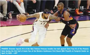  ?? ?? PHOENIX: Brandon Ingram #14 of the New Orleans Pelicans handles the ball against Chris Paul #3 of the Phoenix Suns during the first half of Game Two of the Western Conference First Round NBA Playoffs at Footprint Center on April 19, 2022. —AFP