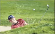  ?? Donald Miralle / Getty Images ?? Patrick Reed hits from the bunker on the first hole during Sunday’s final round of the Farmers Insurance Open at Torrey Pines South in San Diego.