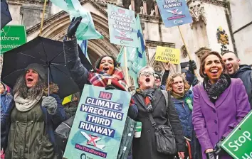  ?? AP ?? ■ Campaigner­s cheer outside the Royal Courts of Justice in London yesterday after winning a court ruling to block the plans for a third runway at Heathrow Airport.