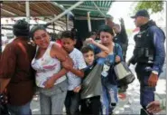  ?? JUAN CARLOS HERNANDEZ — THE ASSOCIATED PRESS ?? Police officers disperse the relatives of prisoners who were waiting to hear news about their family members imprisoned at a police station when a riot broke out Wednesday in Valencia, Venezuela.