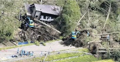  ?? PHOTO: REUTERS ?? Buried . . . Police officers and rescue workers search for survivors in a building damaged by a landslip caused by a powerful earthquake in Atsuma town in Japan’s northern island of Hokkaido, yesterday.