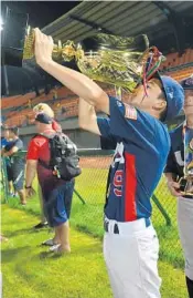  ?? PHOTOS COURTESY OF TERI BUTT ?? Left, Davie’s Spencer Garrett Butt goes into his windup. He helped his USA Baseball 12-Under National Team win the 2017 World Baseball Softball Confederat­ion U-12 Baseball World Cup. Right, Butt drinks from the World Cup during a postgame celebratio­n.