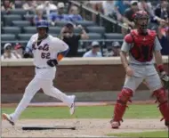  ?? SETH WENIG — THE ASSOCIATED PRESS ?? New York Mets' Yoenis Cespedes, left, scores the winning run past St. Louis Cardinals catcher Eric Fryer on a single hit by Jose Reyes during the ninth inning of a baseball game at Citi Field, Thursday in New York. The Mets defeated the Cardinals 3-2.