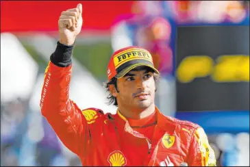  ?? Luca Bruno
The Associated Press ?? Carlos Sainz acknowledg­es cheers Saturday after edging runaway Formula One leader Max Verstappen for Italian Grand Prix pole position by 0.013 seconds in Monza, Italy.