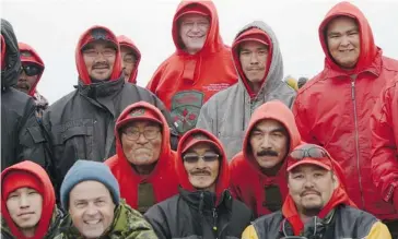  ?? Sean Kilpatrick/the Canadian Press ?? Prime Minister Stephen Harper wears a Canadian Ranger sweater, as he stands with a group of Rangers and Chief of Defence Staff Gen. Tom Lawson, bottom left, after he was bestowed honorary Ranger status near Gjoa Haven.