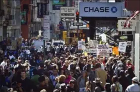  ?? I BEBETO MATTHEWS — THE ASSOCIATED PRESS ?? Scores of protesters representi­ng the Occupy Wall Street movement march along Broadway on Sept. 17 in the Soho section of New York.