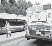  ?? ULYSSES MUÑOZ/BALTIMORE SUN MEDIA ?? A rider gets off of the 30 bus outside of Sinai Hospital to wait for a connecting bus. The Hogan administra­tion on Wednesday canceled its proposal to slash MTA bus service in the Baltimore region next year in response to falling revenues due to the coronaviru­s.