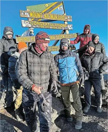  ?? Picture: SUPPLIED ?? TOP OF THE WORLD: Bushmans regular Matt Mullins, front right, at the summit of Mount Kilimanjar­o in September 2023.