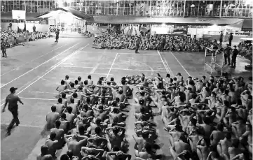  ??  ?? Naked inmates at the Cebu city jail sitting during a joint raid by the Philippine Drug Enforcemen­t Agency and Cebu Police provincial office on illegal drugs and contraband­s. — AFP photo