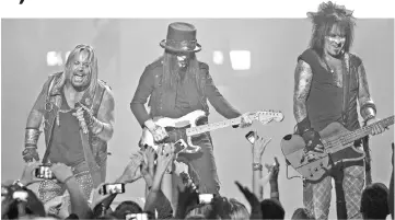  ?? — Reuters file photo ?? Motley Crue band members Vince Neil (left to right), Mick Mars, and Sixx perform during the 2014 iHeartRadi­o Music Festival.