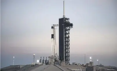  ?? PHOTO: AP ?? A SpaceX Falcon 9 rocket with the company’s Crew Dragon spacecraft onboard is seen after being raised into a vertical position on the launch pad at Launch Complex 39A yesterday at the Kennedy Space Centre in Florida.