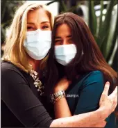  ?? TRIBUNE NEWS SERVICE ?? Peggy Kelley, left, a Protestant Christian chaplain, stands for a portrait with Jillian Katz, an Orthodox Jewish nurse, on Cedars-Sinai's COVID-19 unit in the Healing Gardens on Friday, March 12 in Los Angeles.