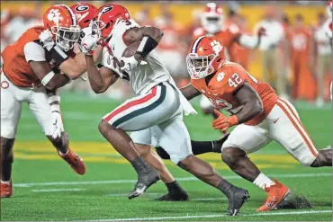  ?? Jim Dedmon/USA TODAY Sports ?? Clemson Tigers linebacker LaVonta Bentley (42) chases down Georgia Bulldogs running back Zamir White (3) during the second half at Bank of America Stadium.