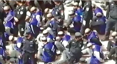  ??  ?? CRUEL CRACKDOWN: A video posted on Twitter and believed to depict blindfolde­d and shackled detainees from China’s Uighur minority